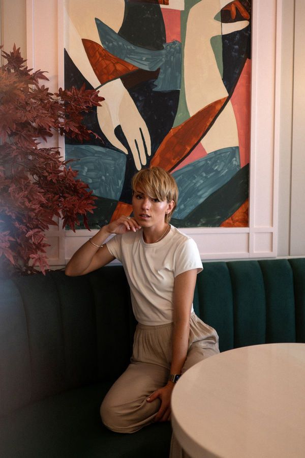 Al Bocconcino — Elena at green velvet booth with abstract painting